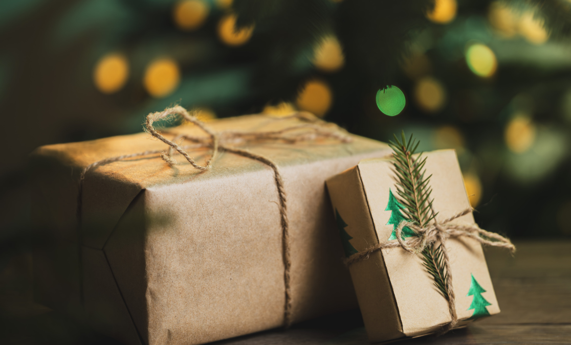 Wrapped gifts beside a Christmas tree