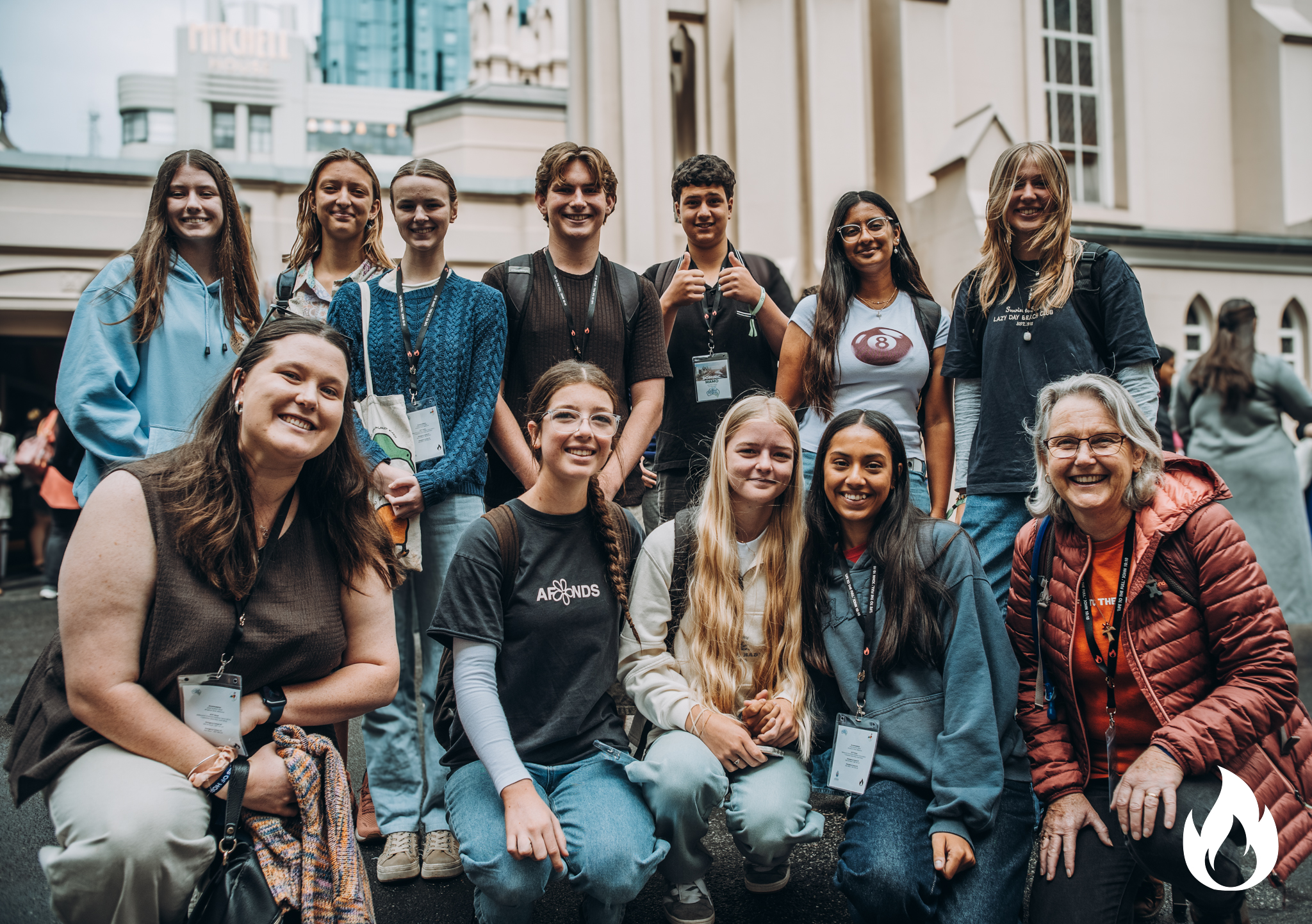 Group of people posing together outdoors.