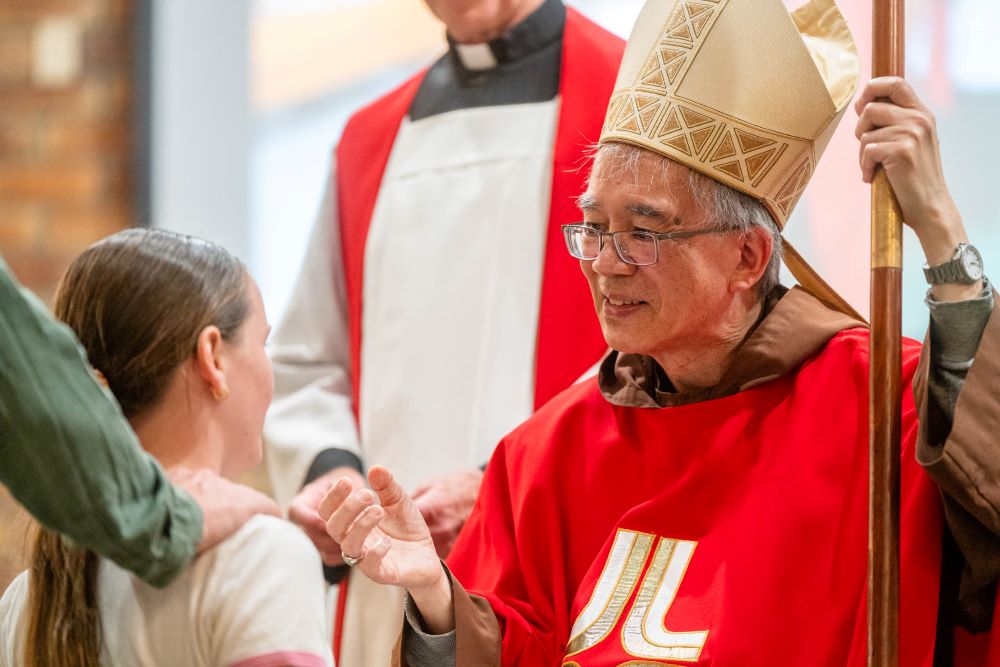 Bishop Greg confirming a young girl.